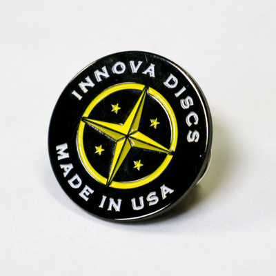Shows the Innova Proto Star Lapel Pin Button against a white background. The colors are black background with white for "Innova Discs, Made In USA" and yellow for the star and circle graphic.