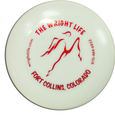 WHAM-O WRIGHT LIFE GLOW MINI - top view of disc made of whitish glow material with a red The Wright Life stamp.